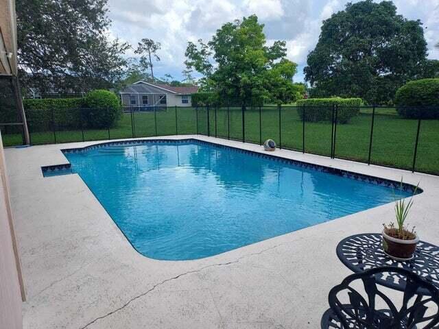 a view of a backyard with swimming pool