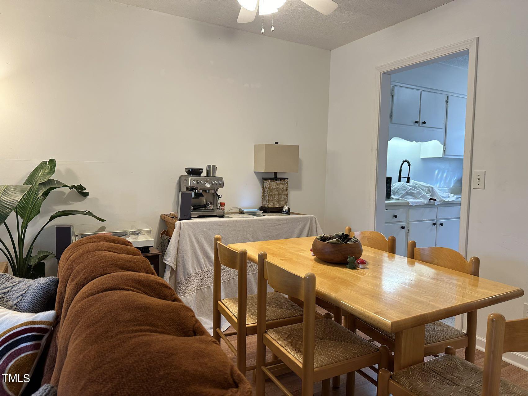 a living room with furniture and two mirrors