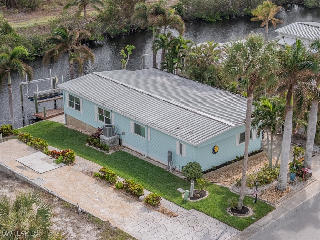 an aerial view of a house with garden space and sitting area