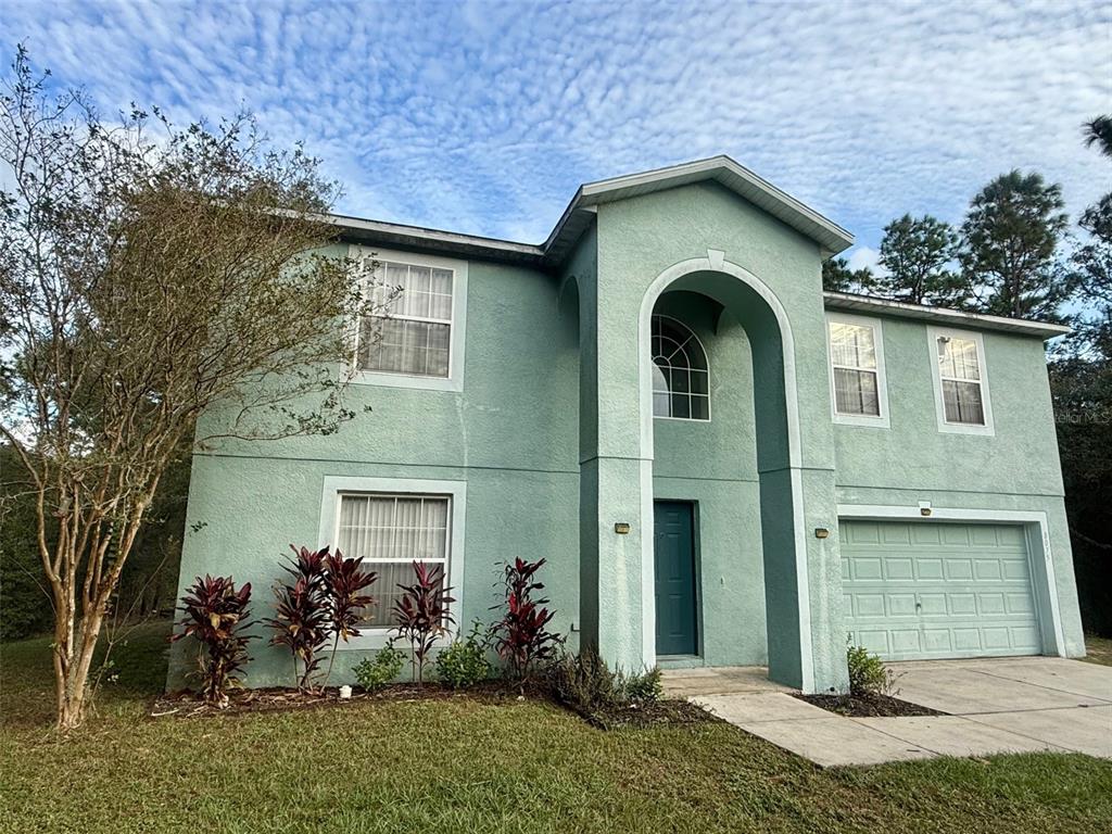 a front view of a house with a yard