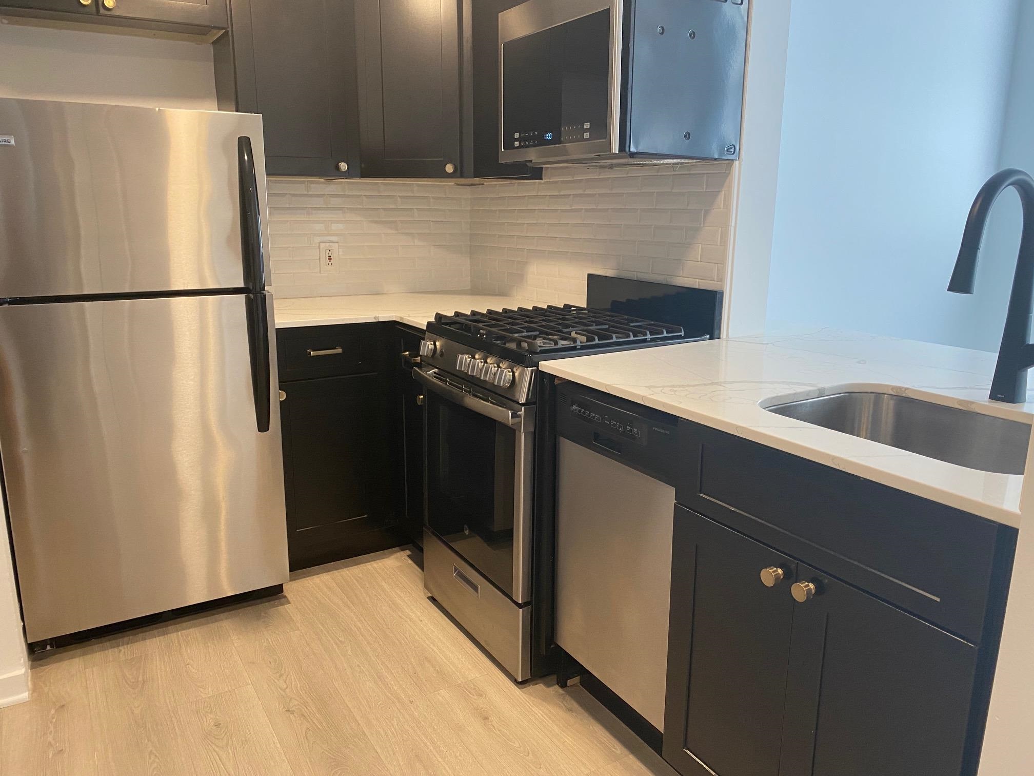 a kitchen with a refrigerator and a sink