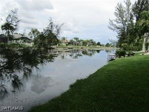 a view of a lake with houses in back