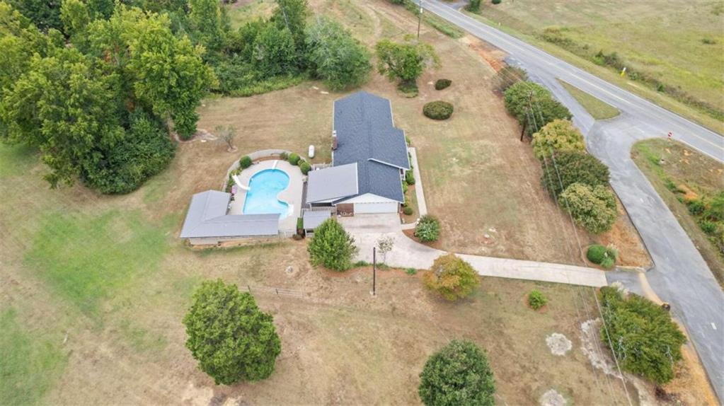 an aerial view of a house with a yard and potted plants