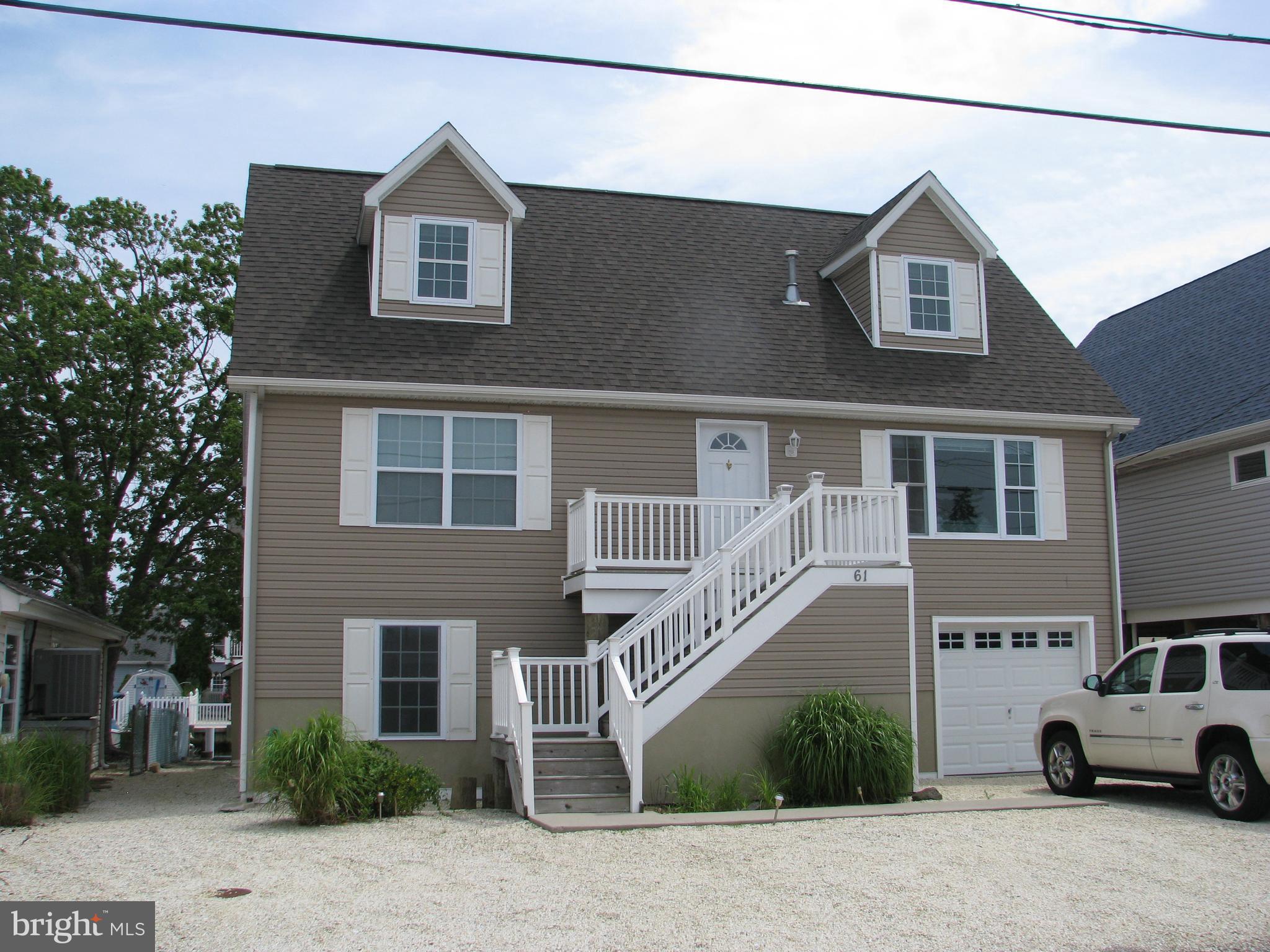 a view of multiple house with car parked