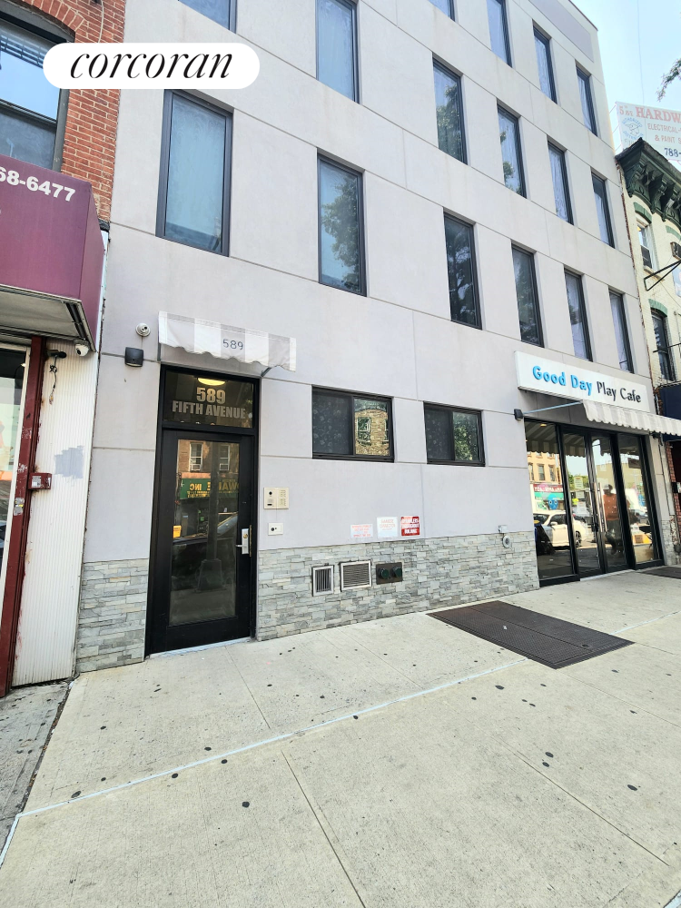 a view of a brick building with many windows