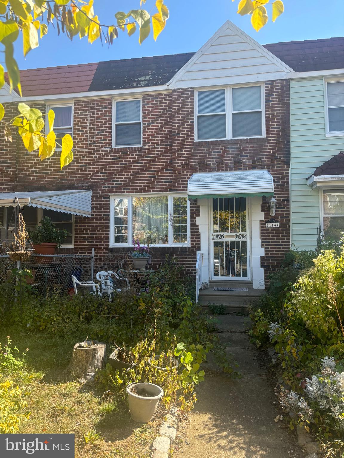 a front view of a house with a garden and pathway