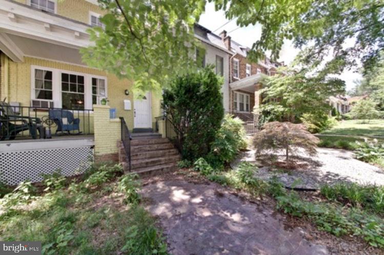 a view of a house with a yard and sitting area