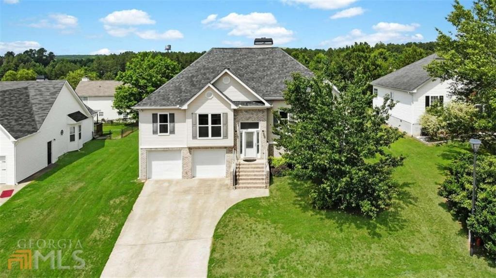 an aerial view of a house with a yard