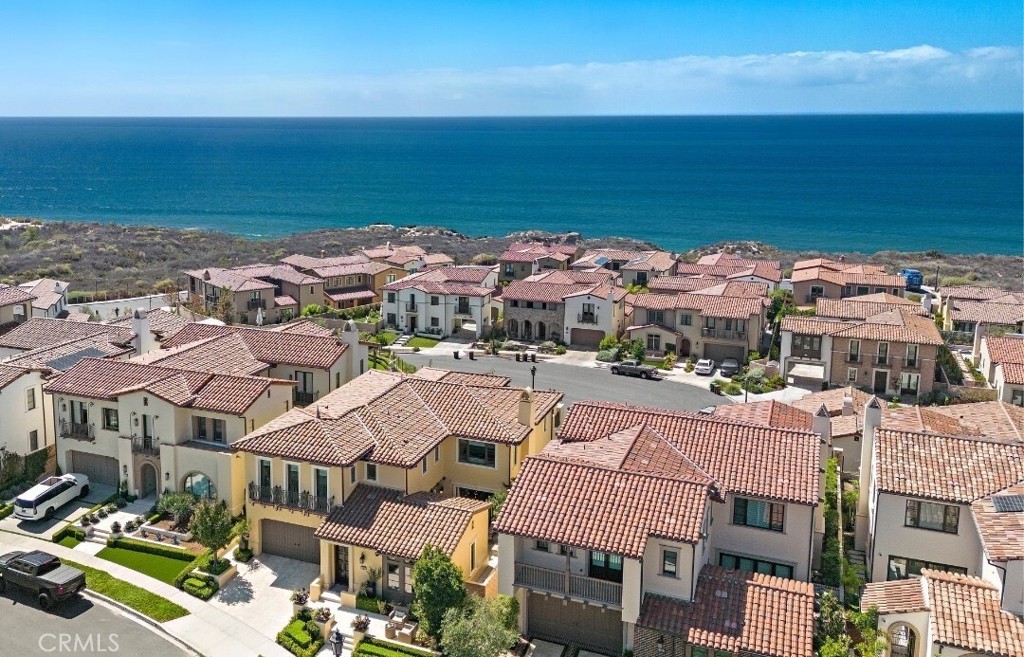 a view of multiple houses with an ocean