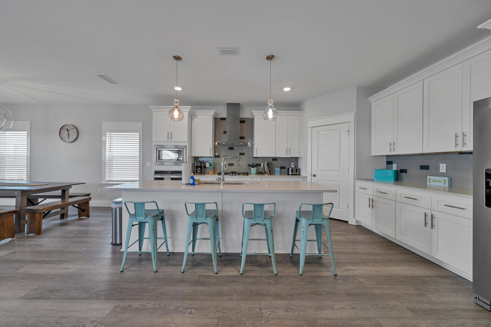 a kitchen with stainless steel appliances granite countertop a table chairs sink refrigerator and cabinets