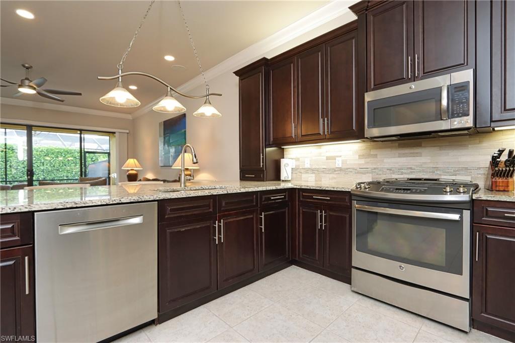 a kitchen with a sink stove and microwave