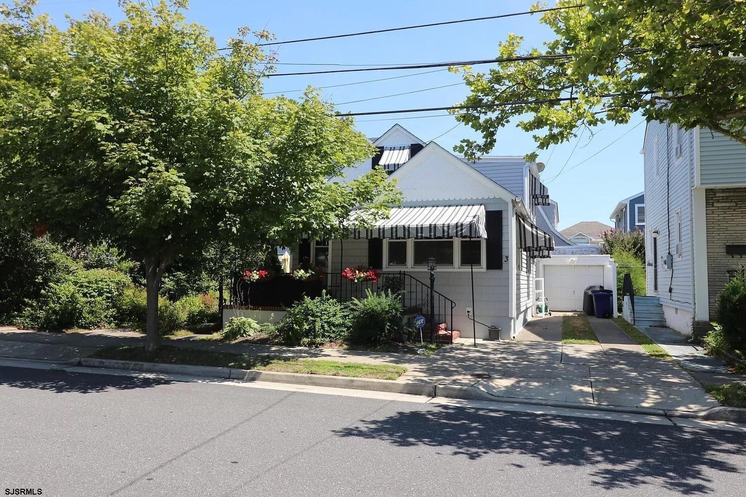 a front view of a house with a yard and a garage