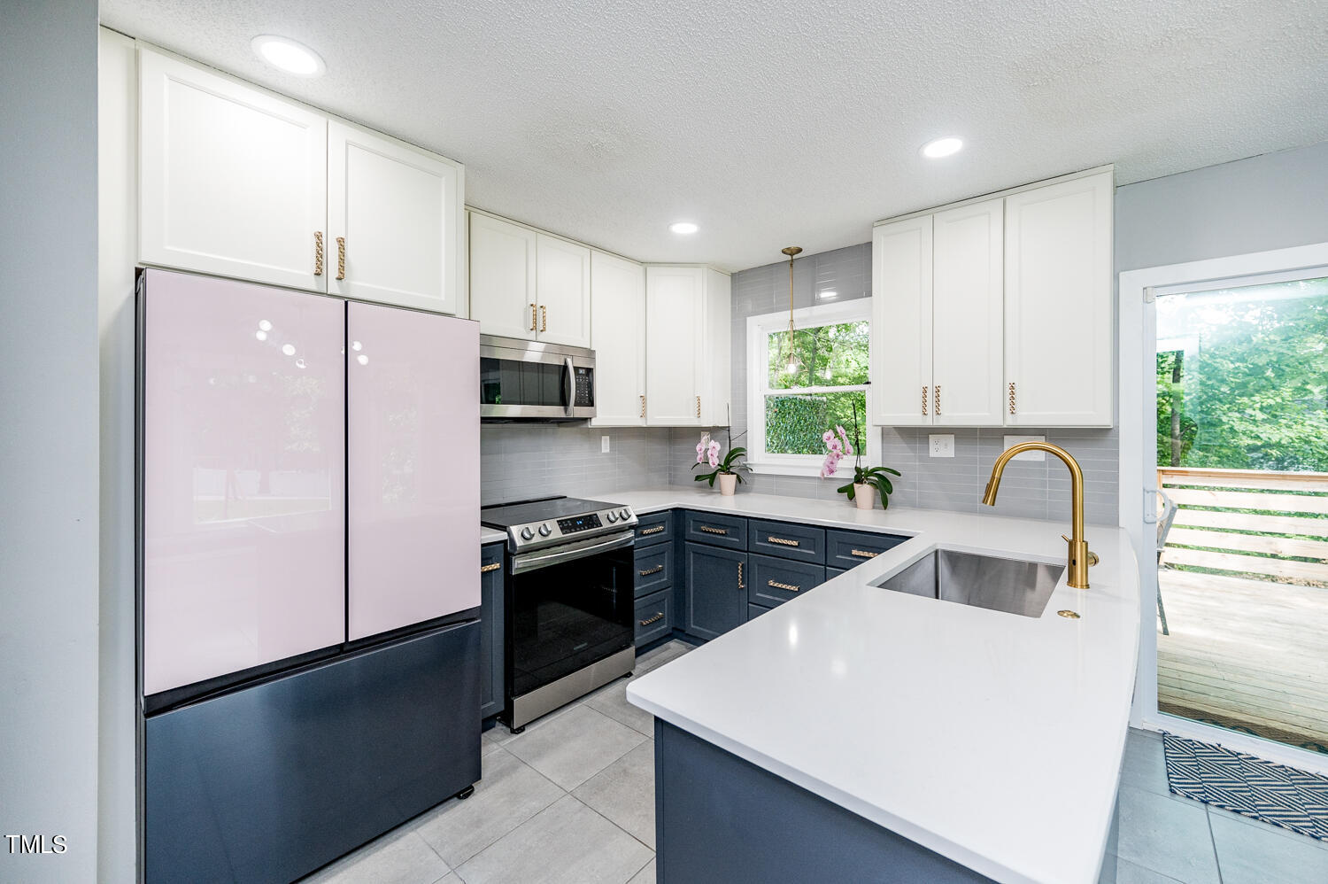 a kitchen with a refrigerator stove and sink