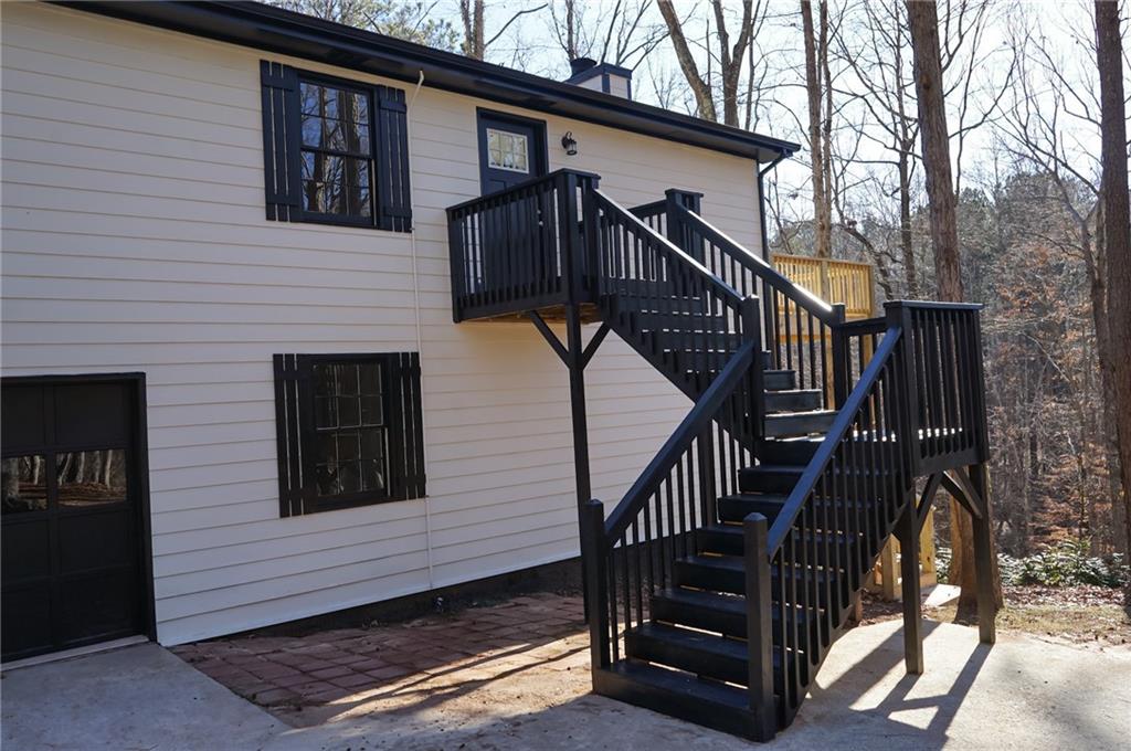 a view of a house with backyard and deck