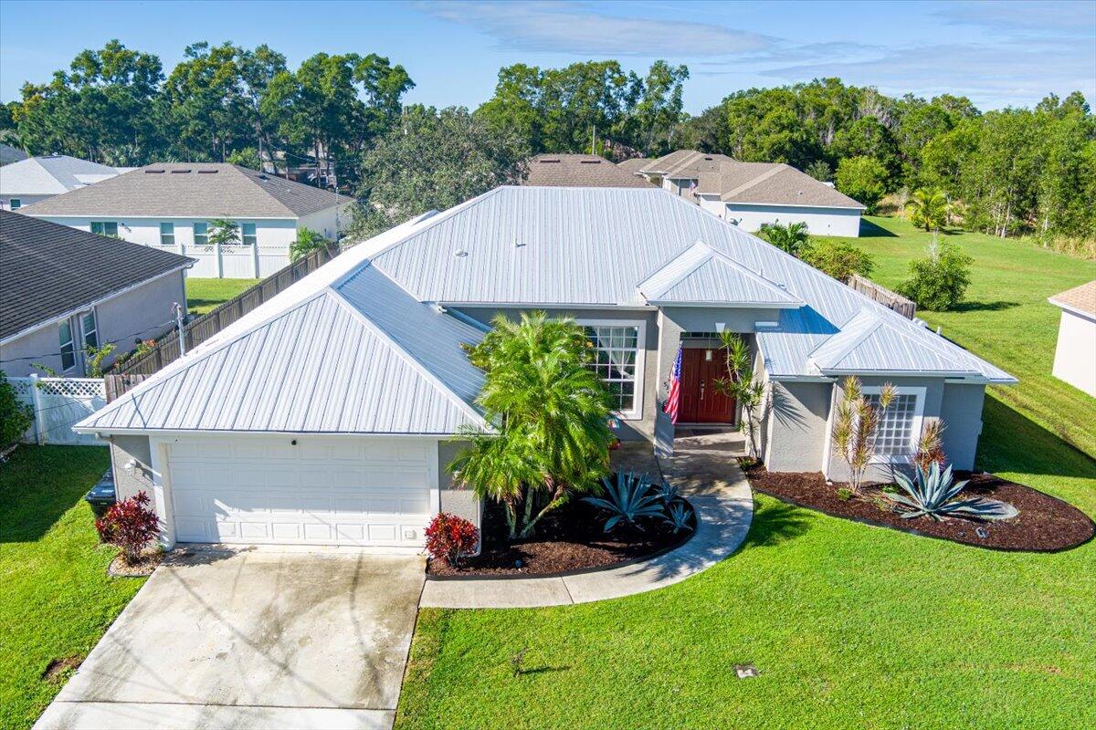 a aerial view of a house with table and chairs under an umbrella