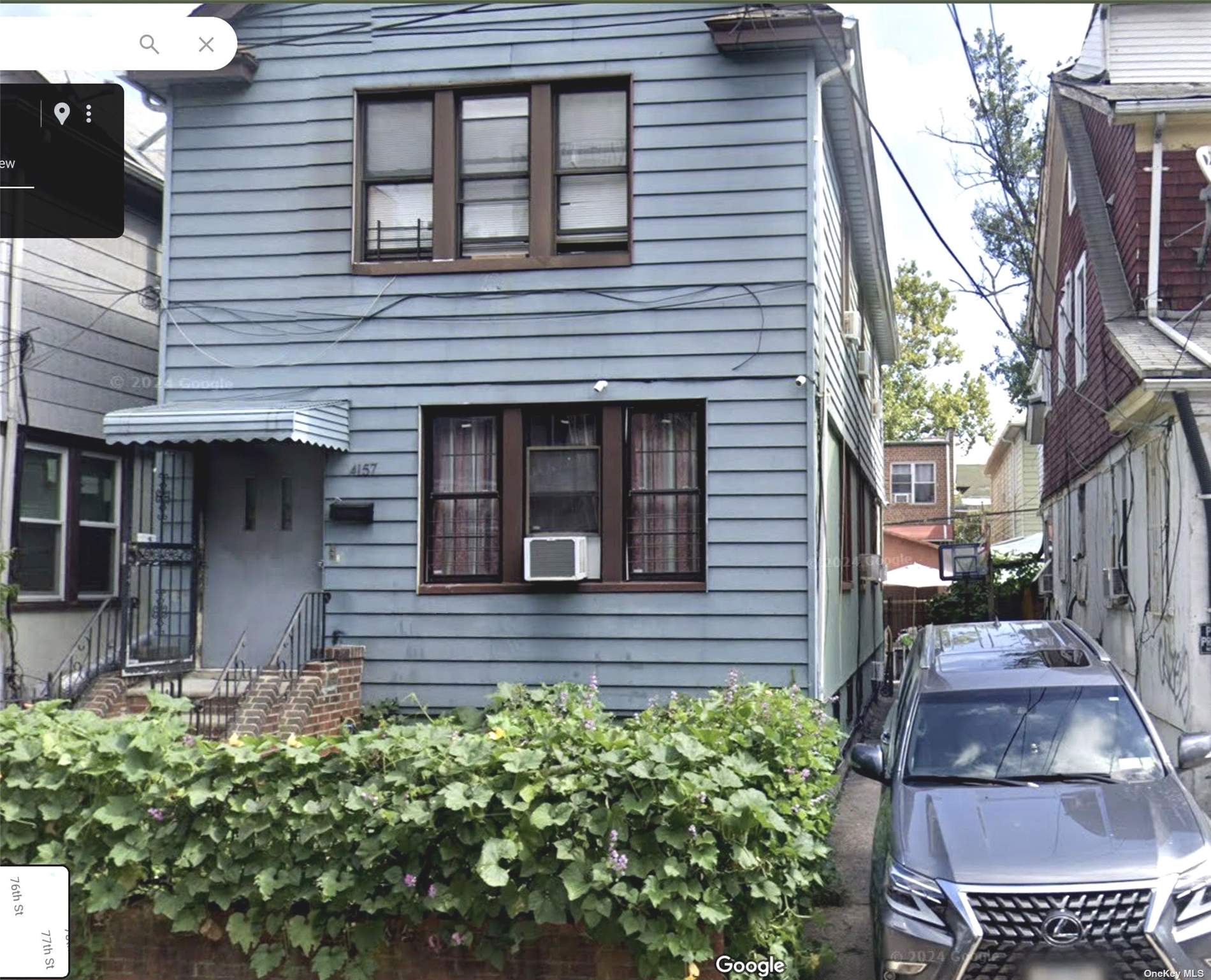 a view of a house with brick walls