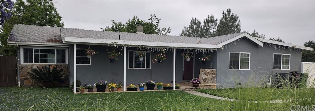 a view of a house with garden and porch