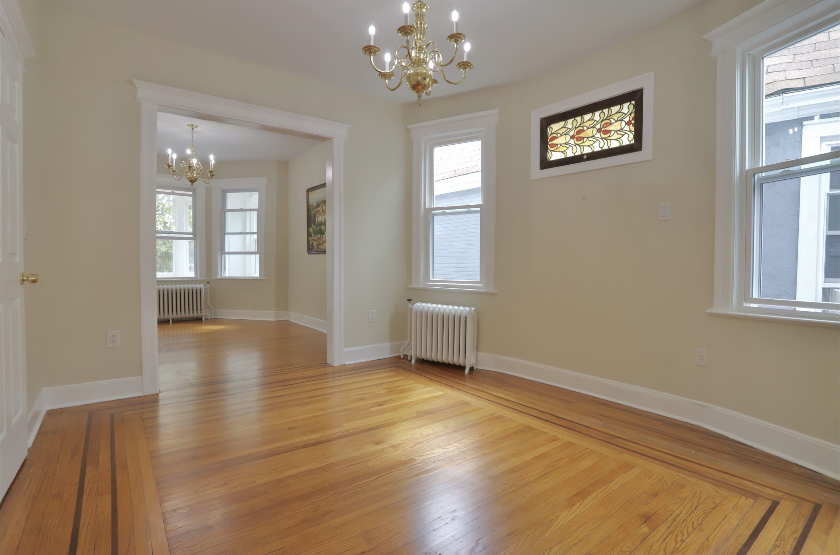 wooden floor in an empty room with a window