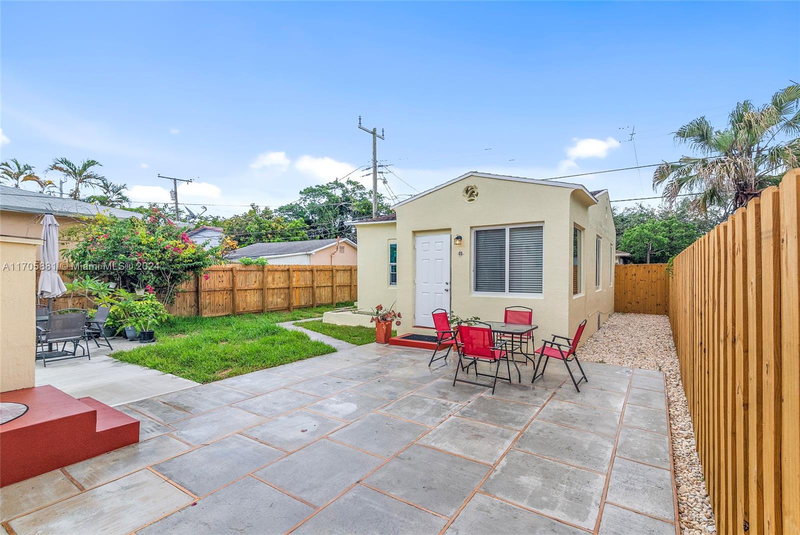 a view of a patio with a table and chairs and potted plants