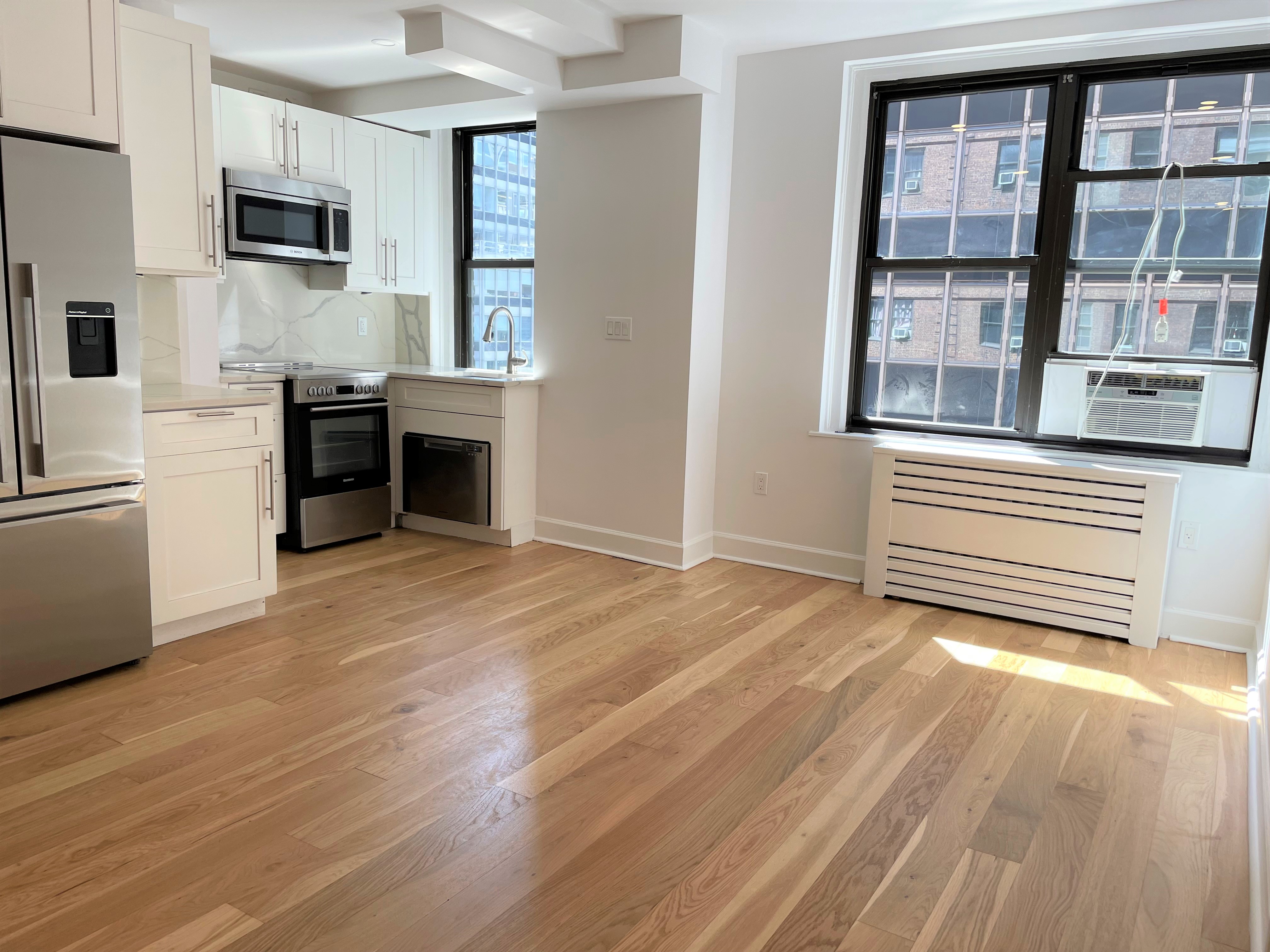 a view of a kitchen with microwave and cabinets