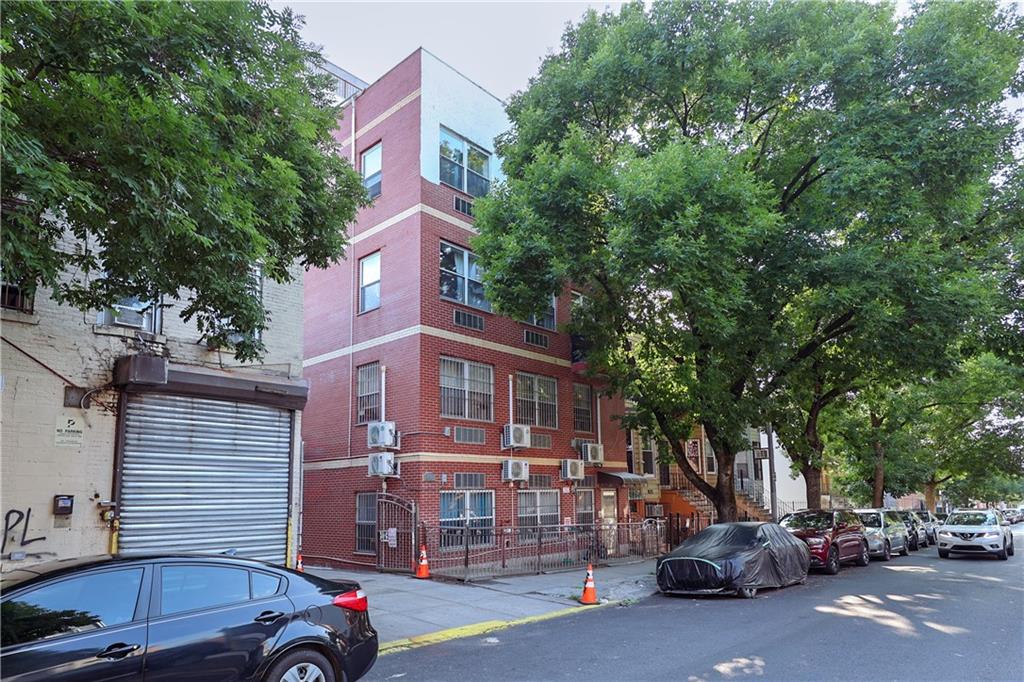 a view of a cars park in front of a building