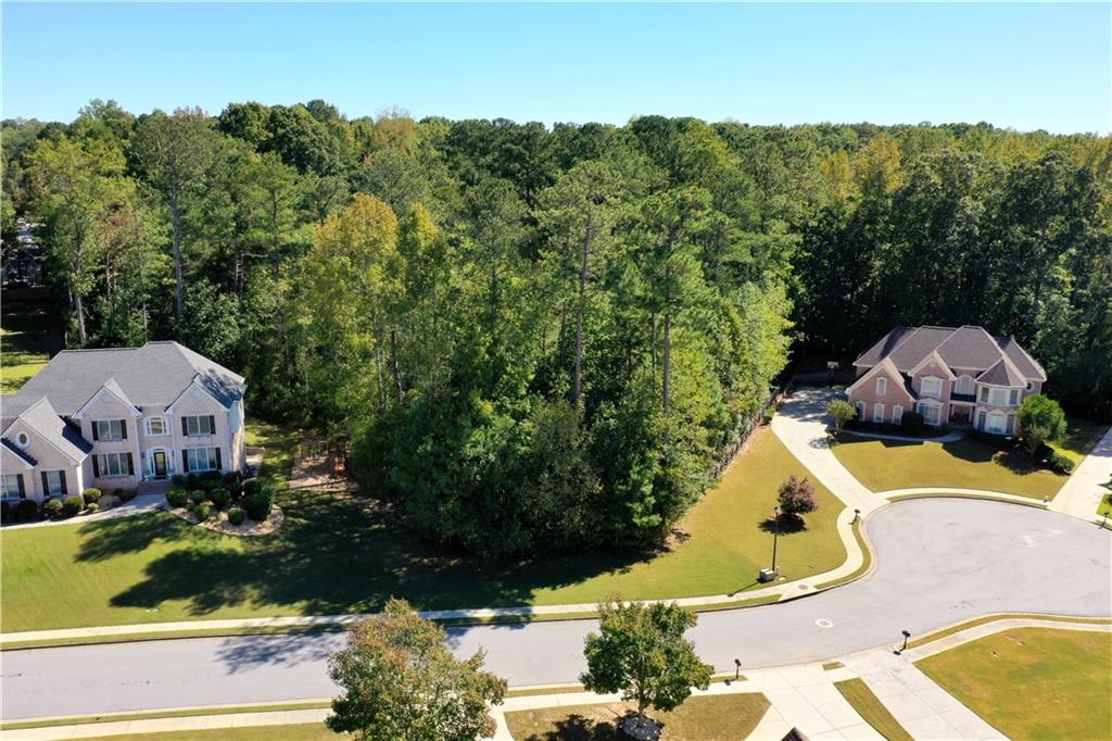 an aerial view of a house with yard swimming pool and outdoor seating