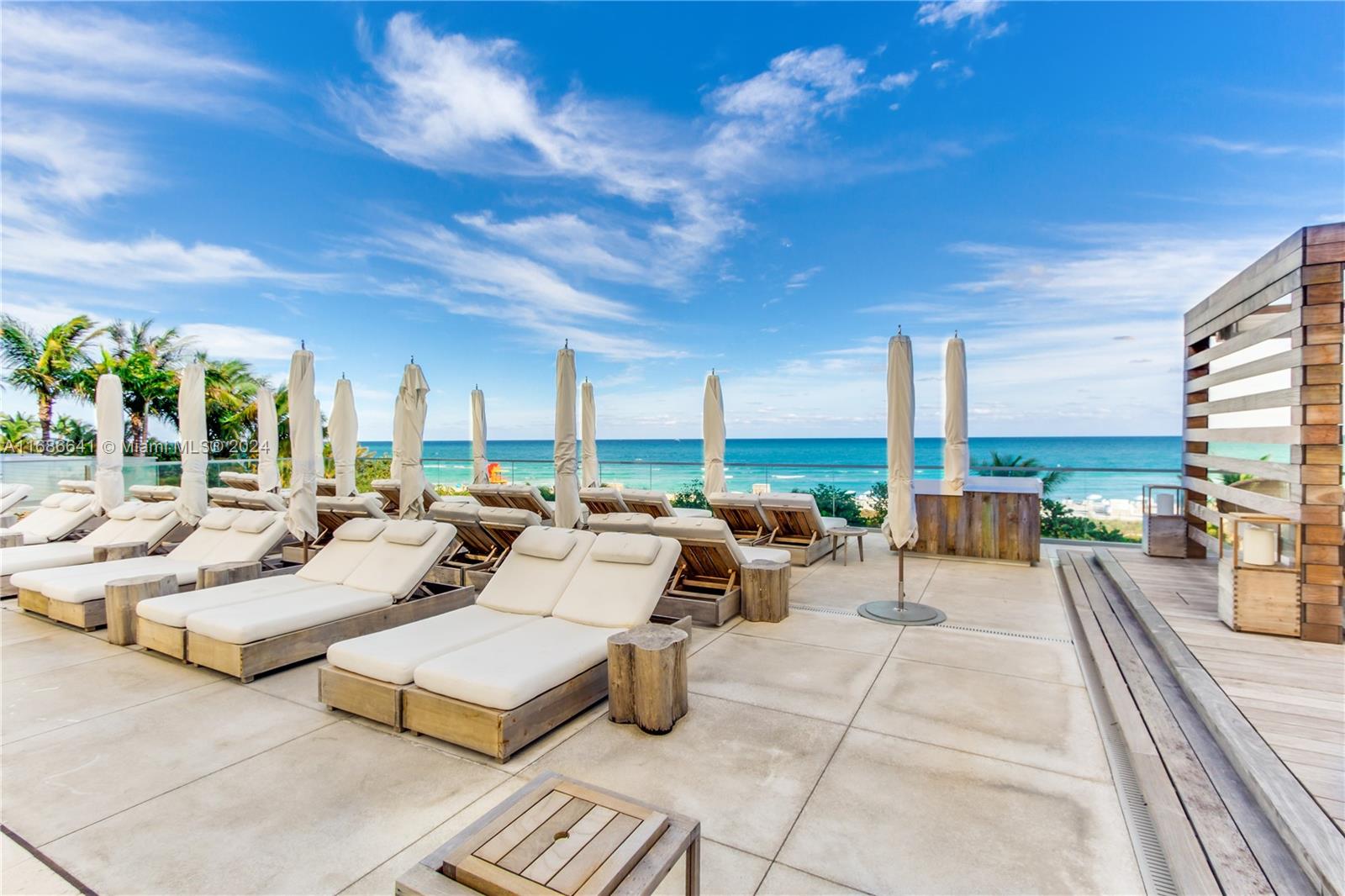 a living room with couches and coffee table with garden view