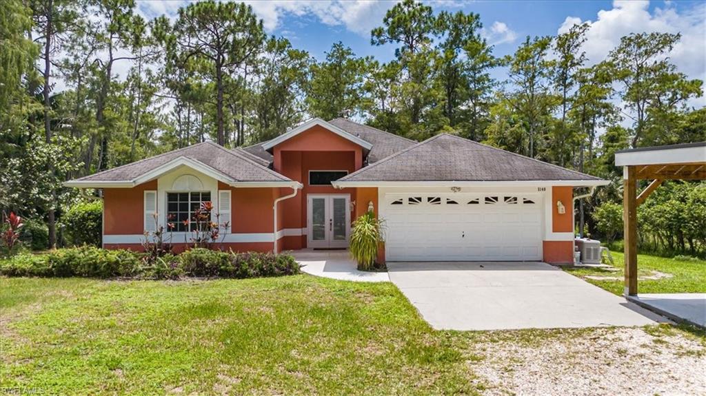 Ranch-style home with a front lawn, central air condition unit, and a garage