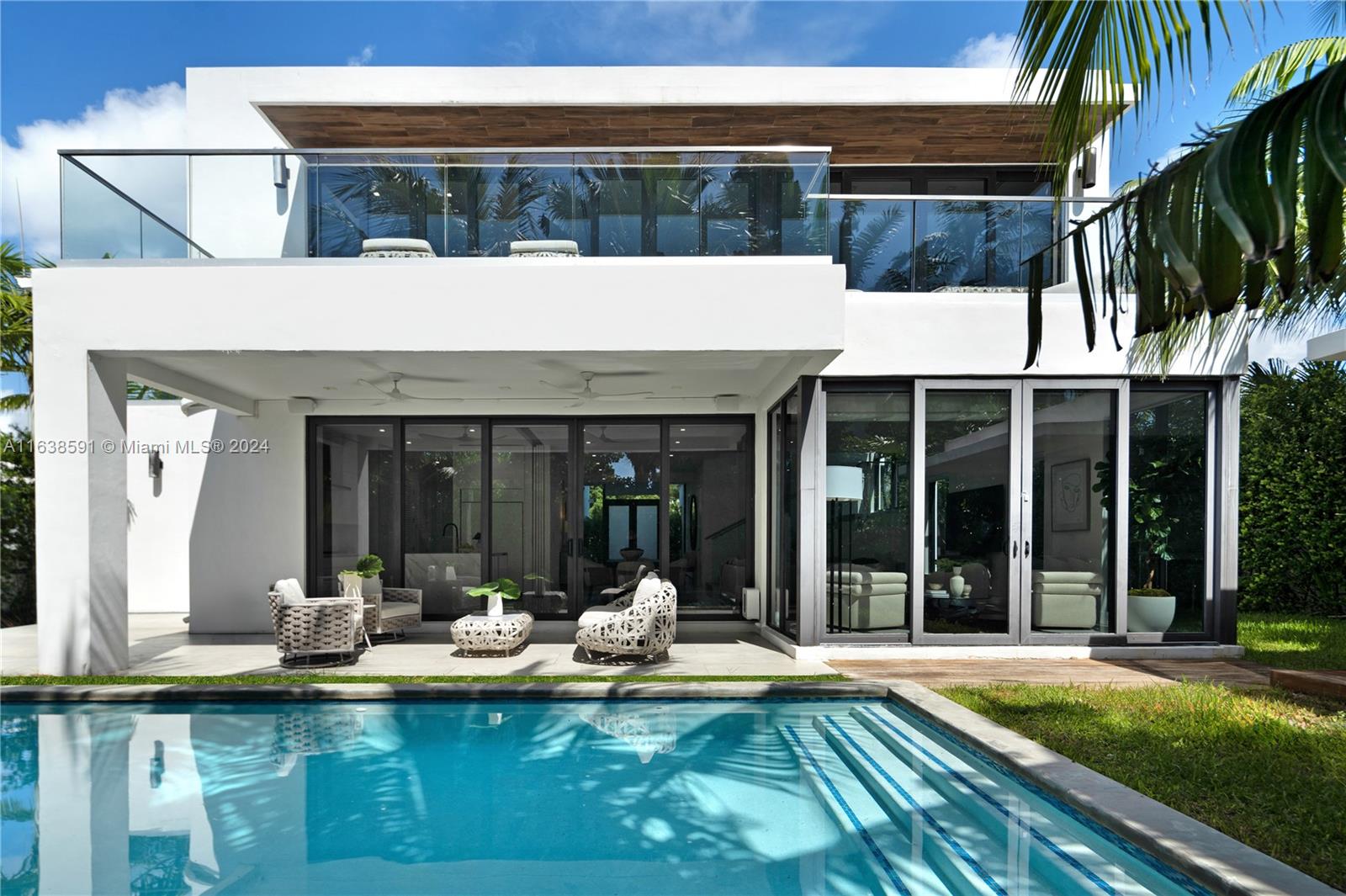 a view of a house with swimming pool and porch with furniture