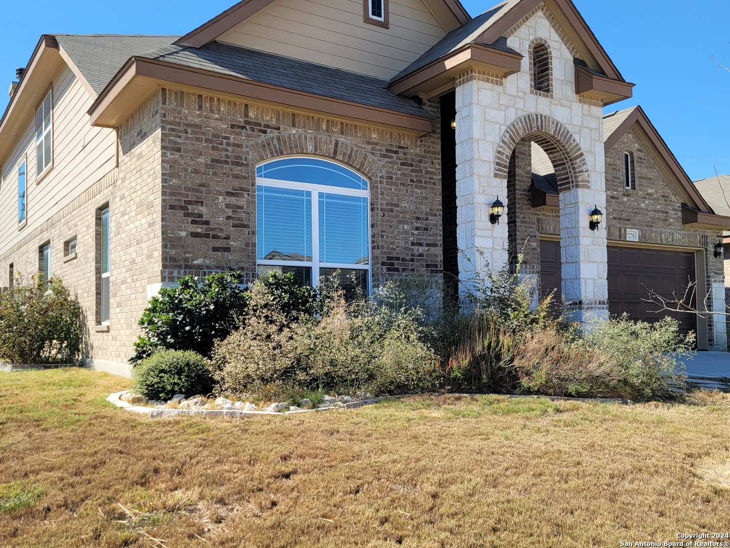 a front view of a house with a yard