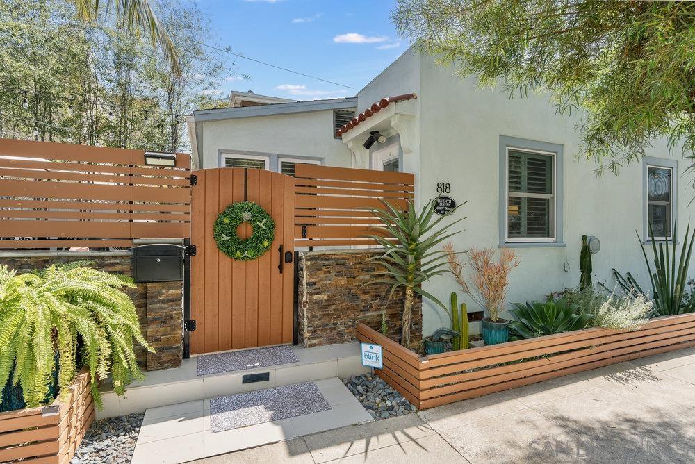 a backyard of a house with outdoor seating