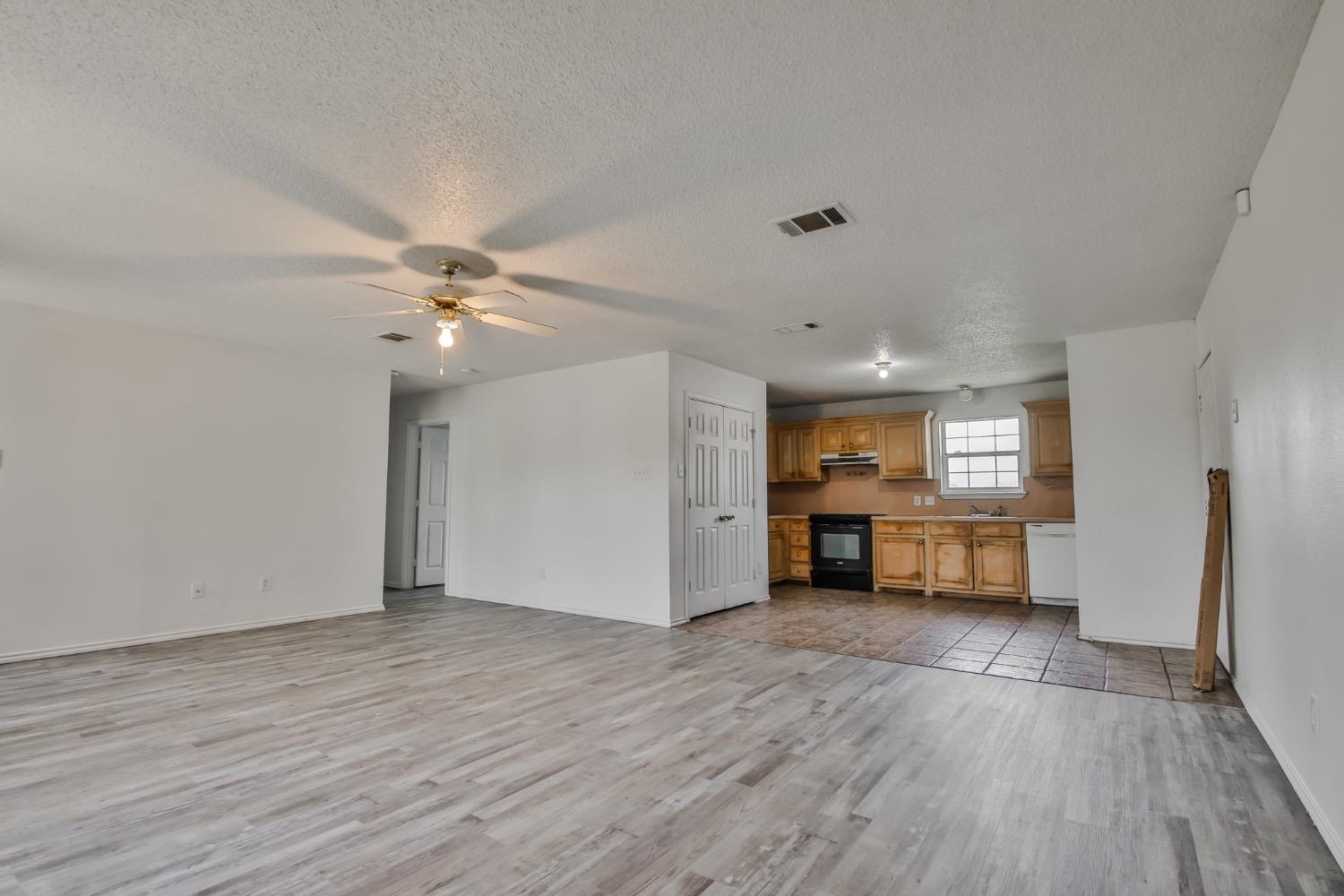 an empty room with wooden floor and workspace