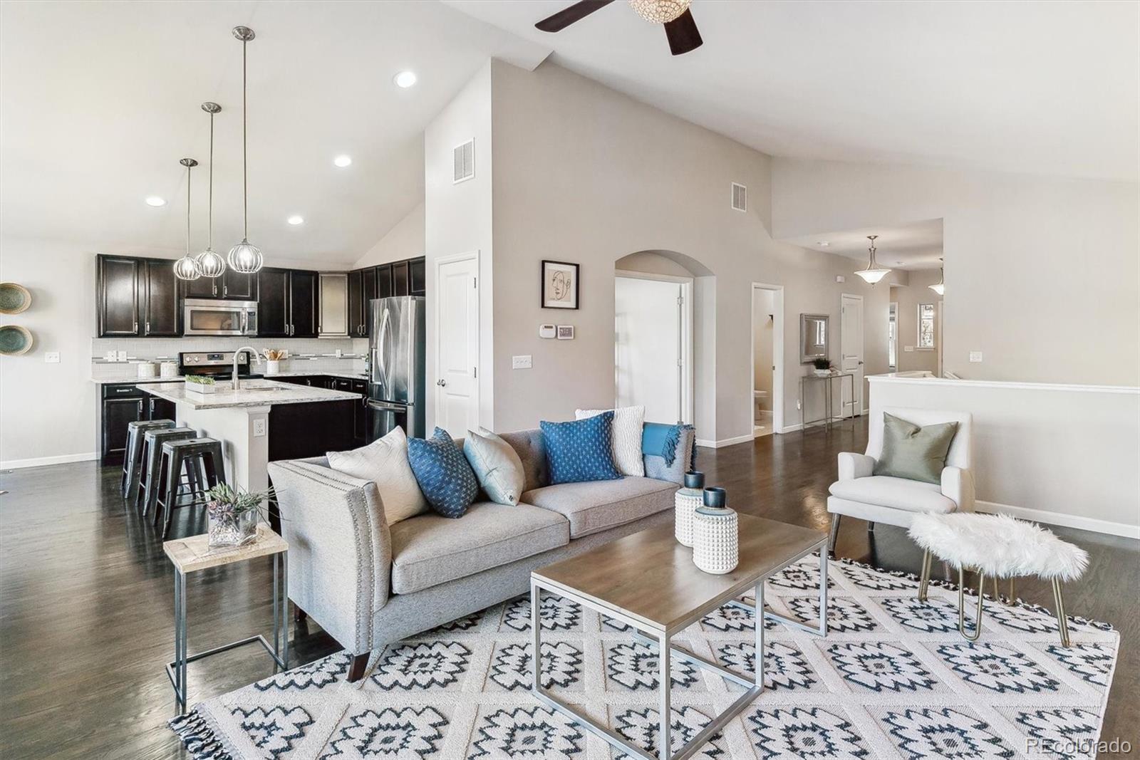 a living room with furniture and kitchen view