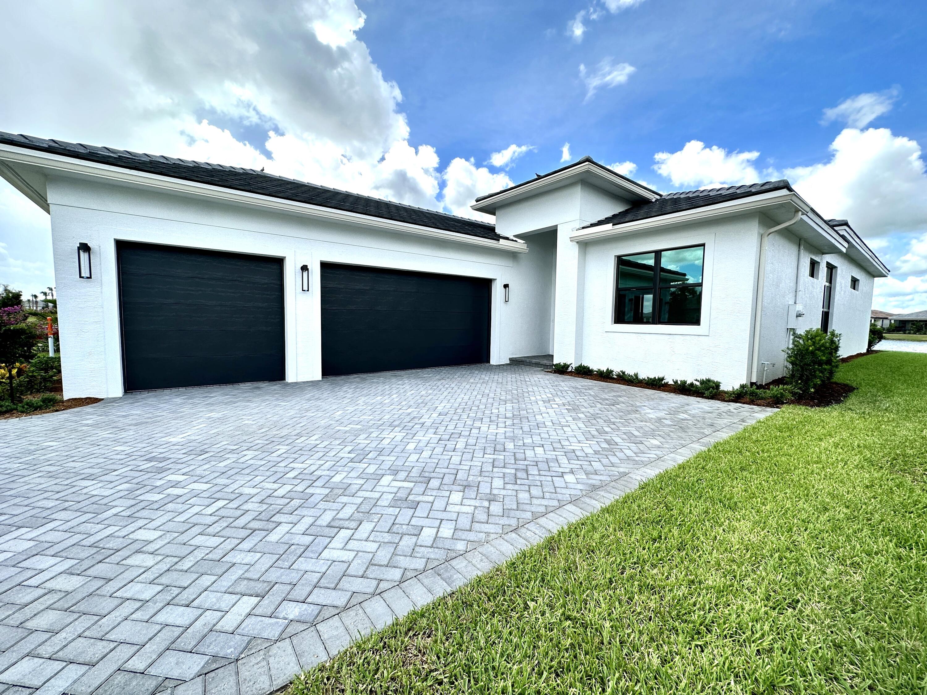 a view of a house with a yard and garage