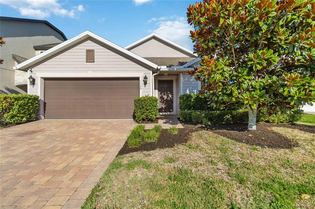 a front view of a house with a yard and garage