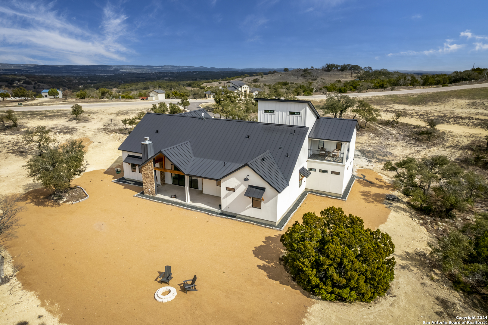 an aerial view of a house with a ocean view