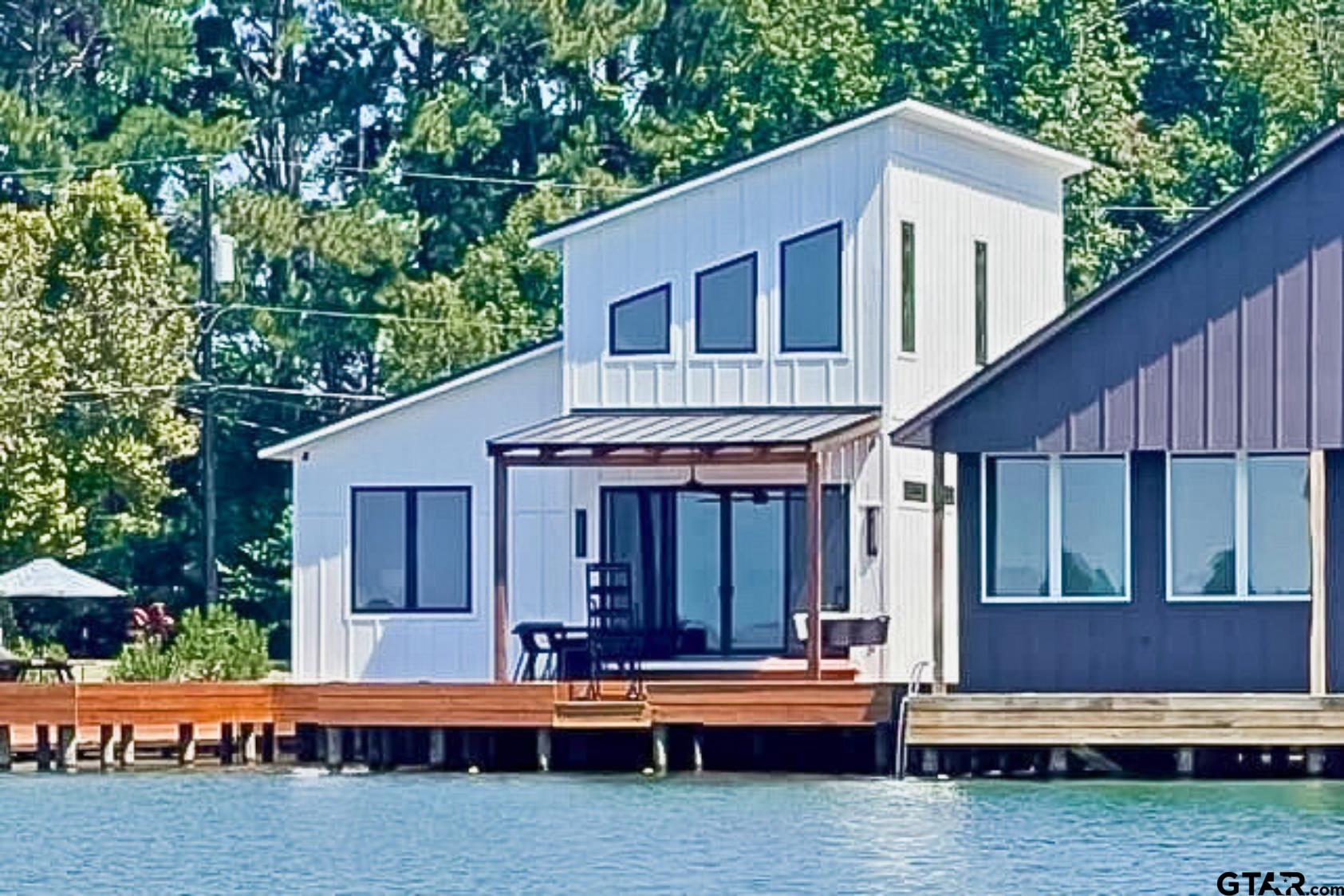 a view of house with backyard and outdoor seating