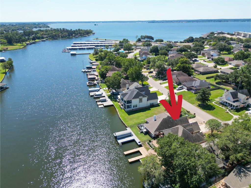 an aerial view of a house with a garden and lake view