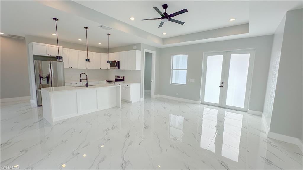 a large white kitchen with a large window