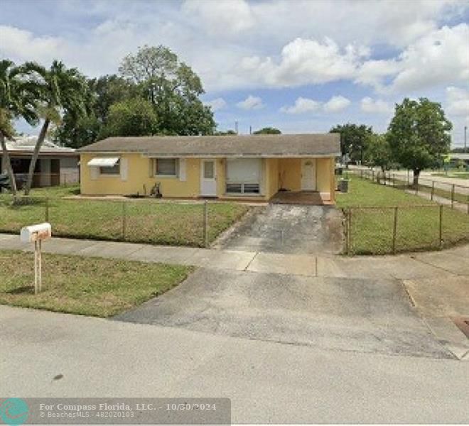 a view of a house with a backyard and a garage