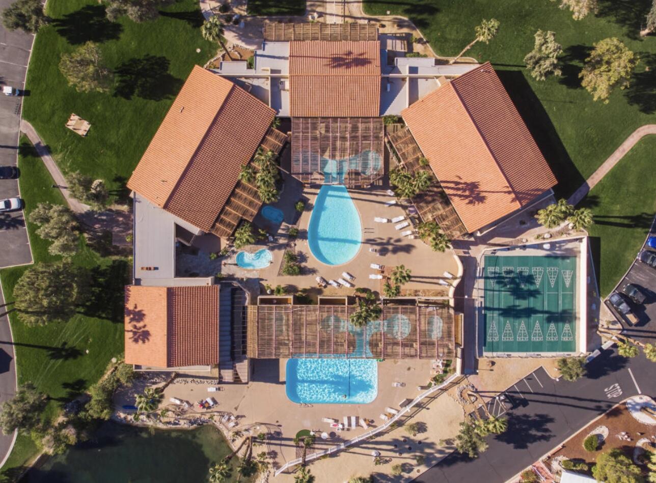 an aerial view of a house with a yard and balcony