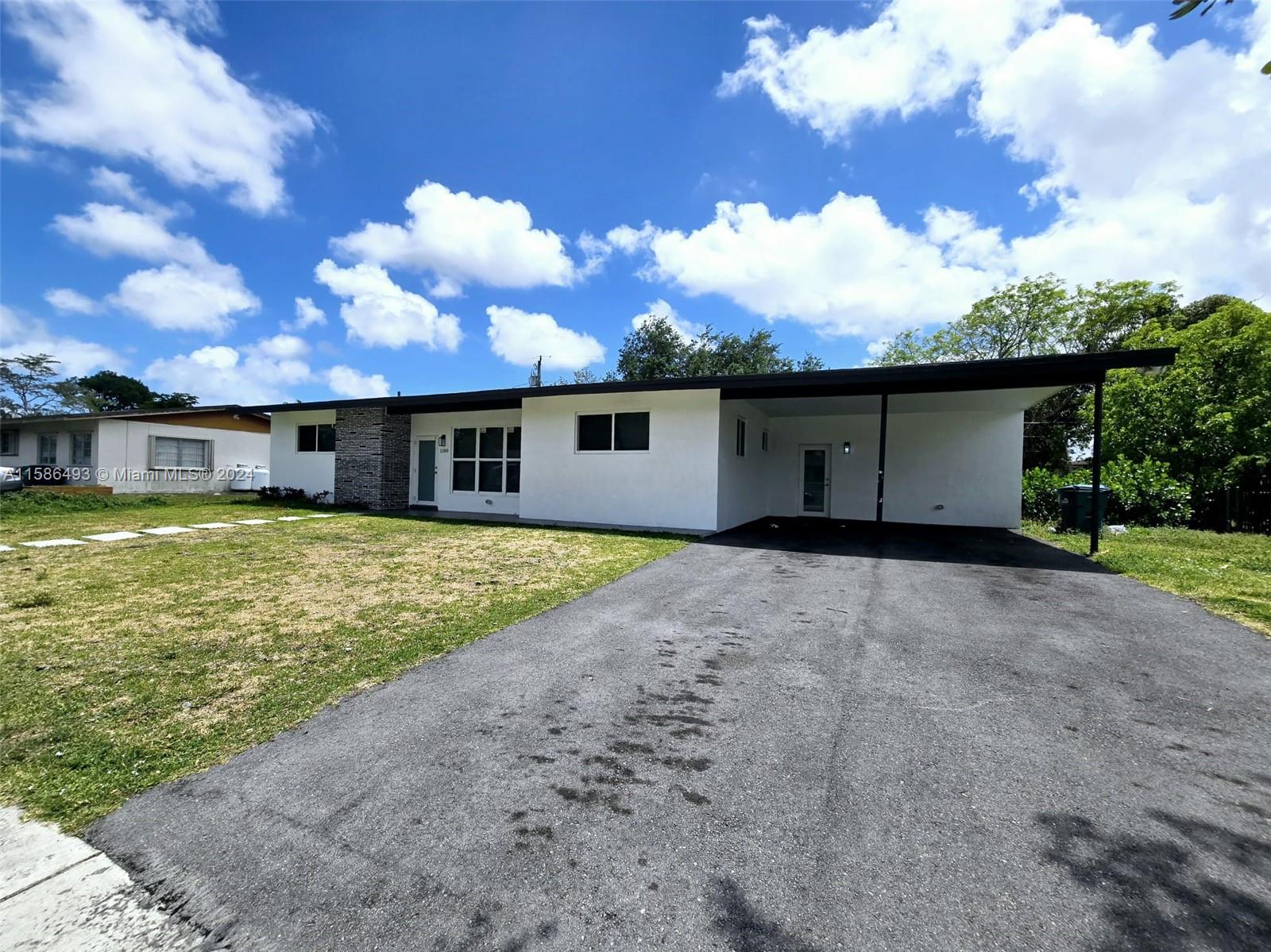 a view of a house with a backyard