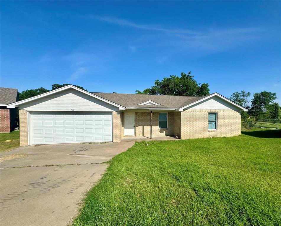 a view of front of house with a yard and garage