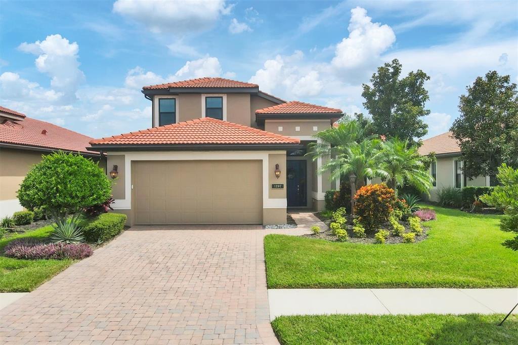 a front view of a house with a yard and garage