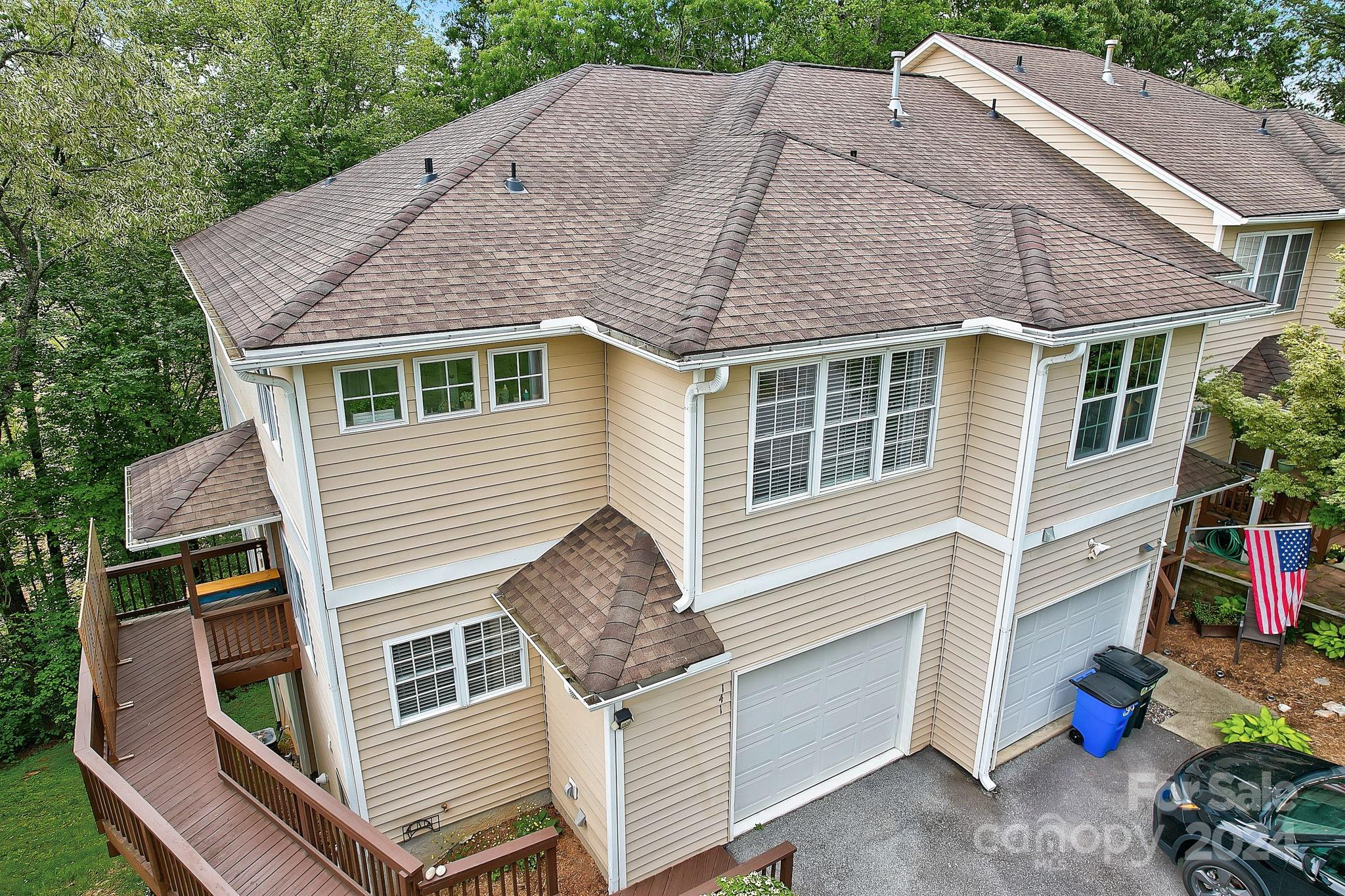 a aerial view of a house with a yard and balcony