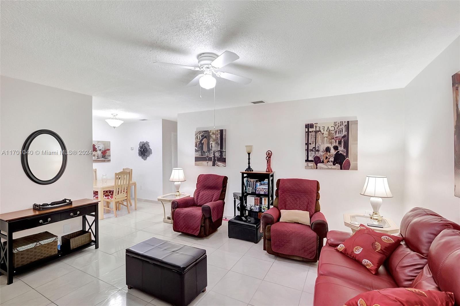 a living room with furniture a couch and a chandelier