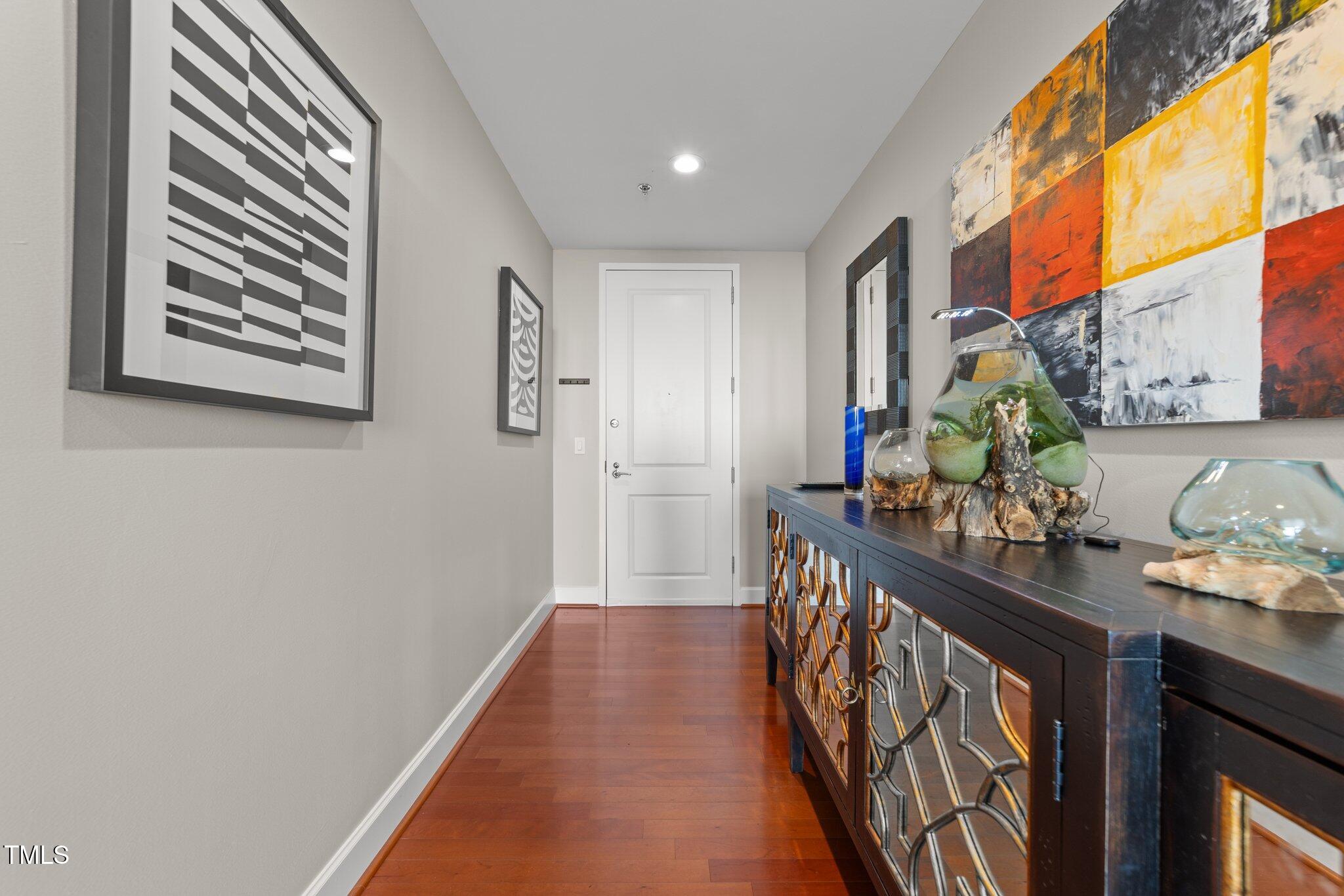 a view of hallway with wooden floor