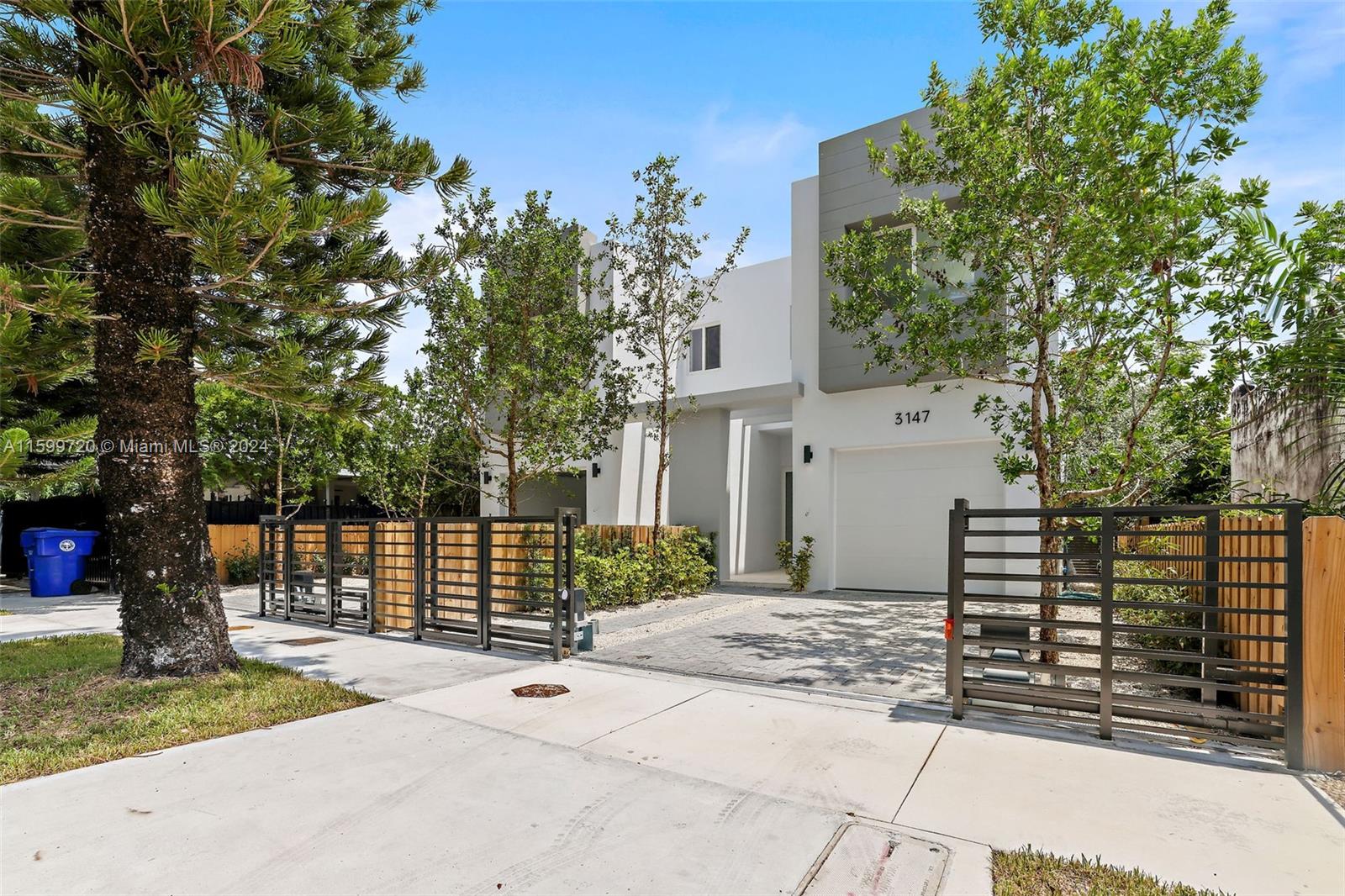 a front view of a house with a tree