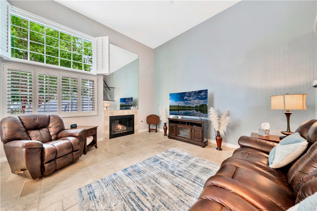 a living room with furniture window and a fireplace