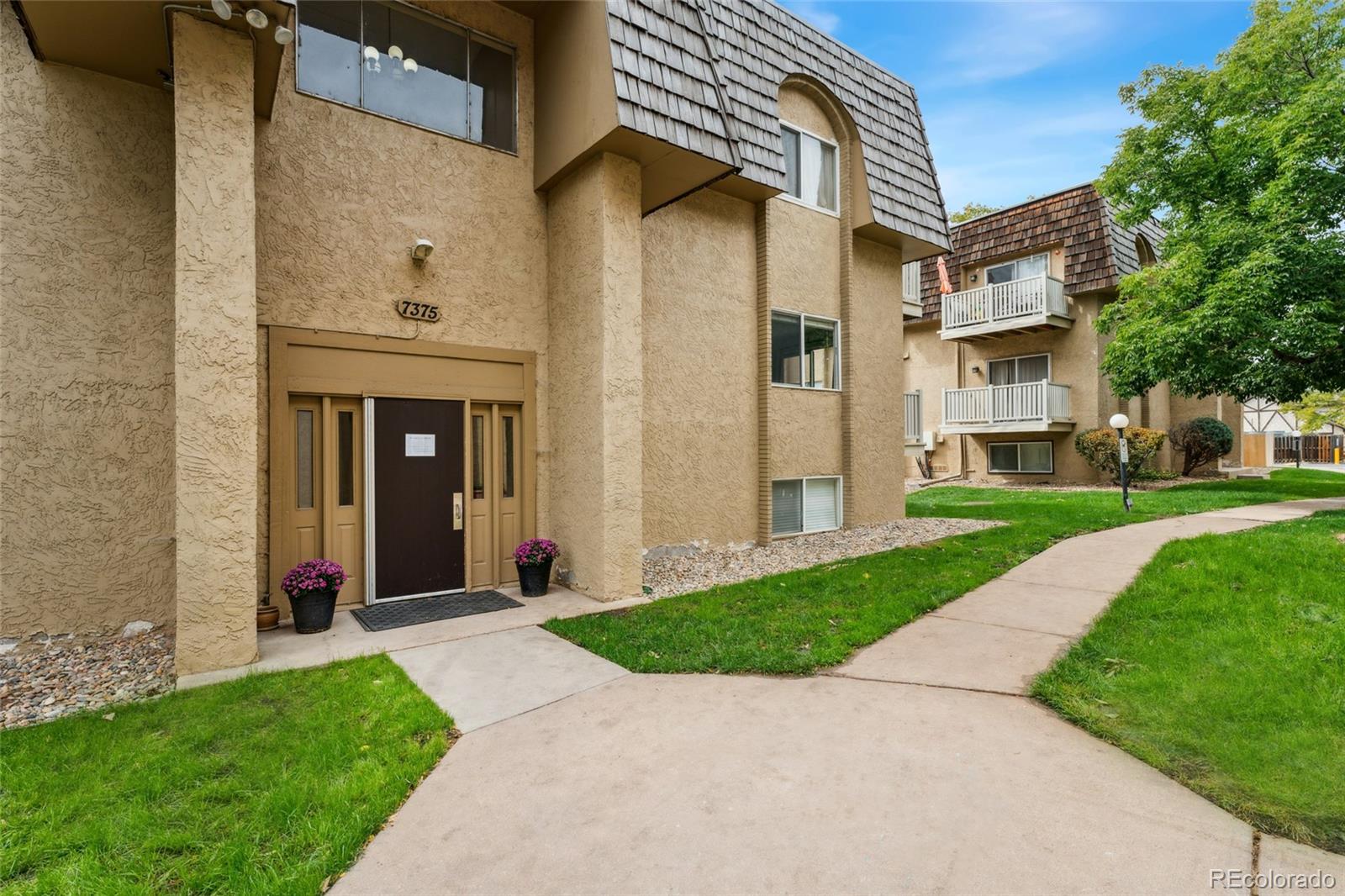 a view of a front door and small yard